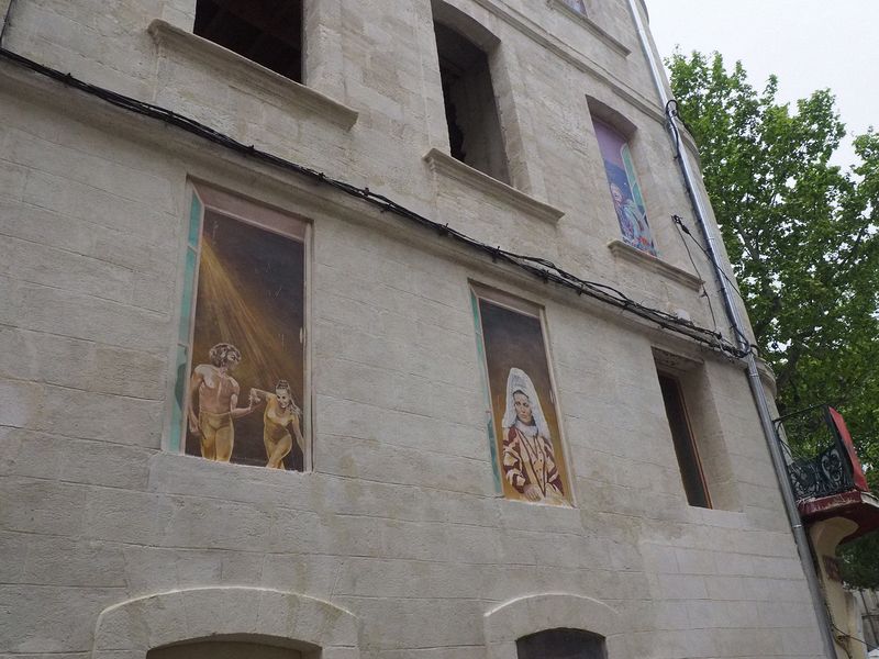 Some buildings have paintings in the windows